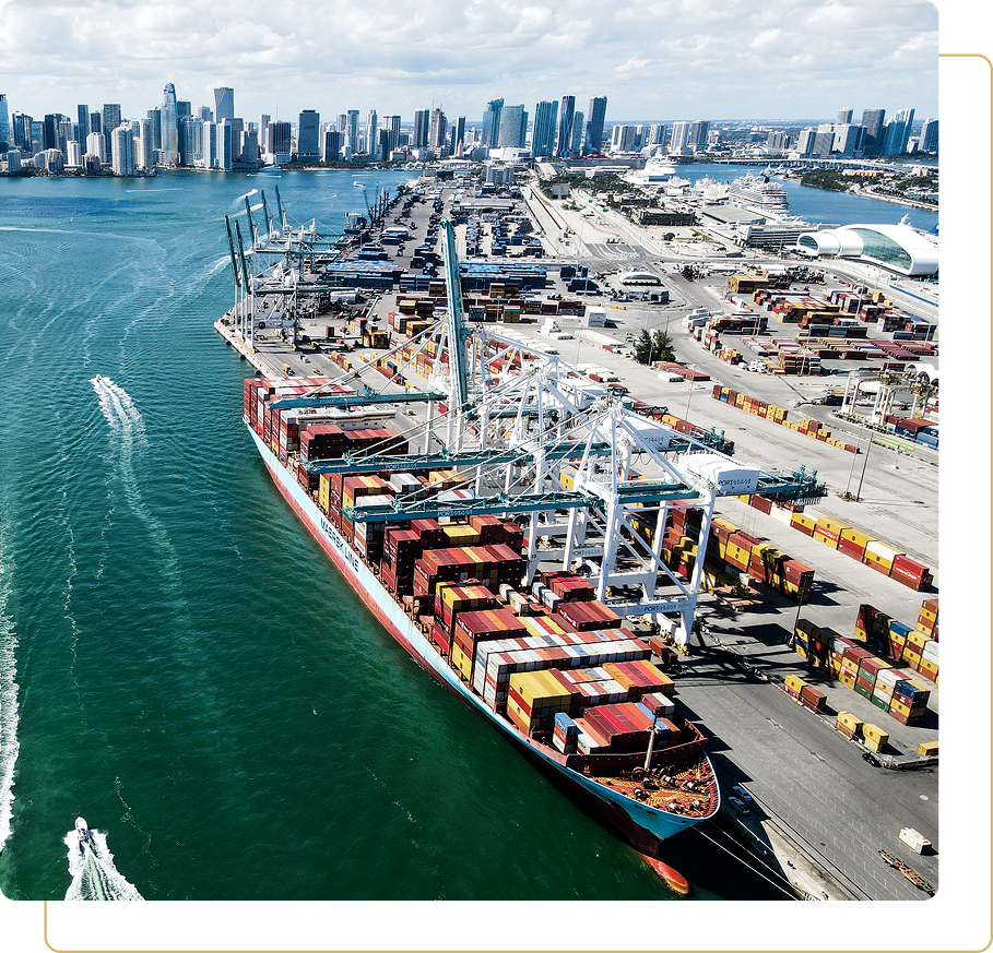 Cargo ship docked at bustling city port.